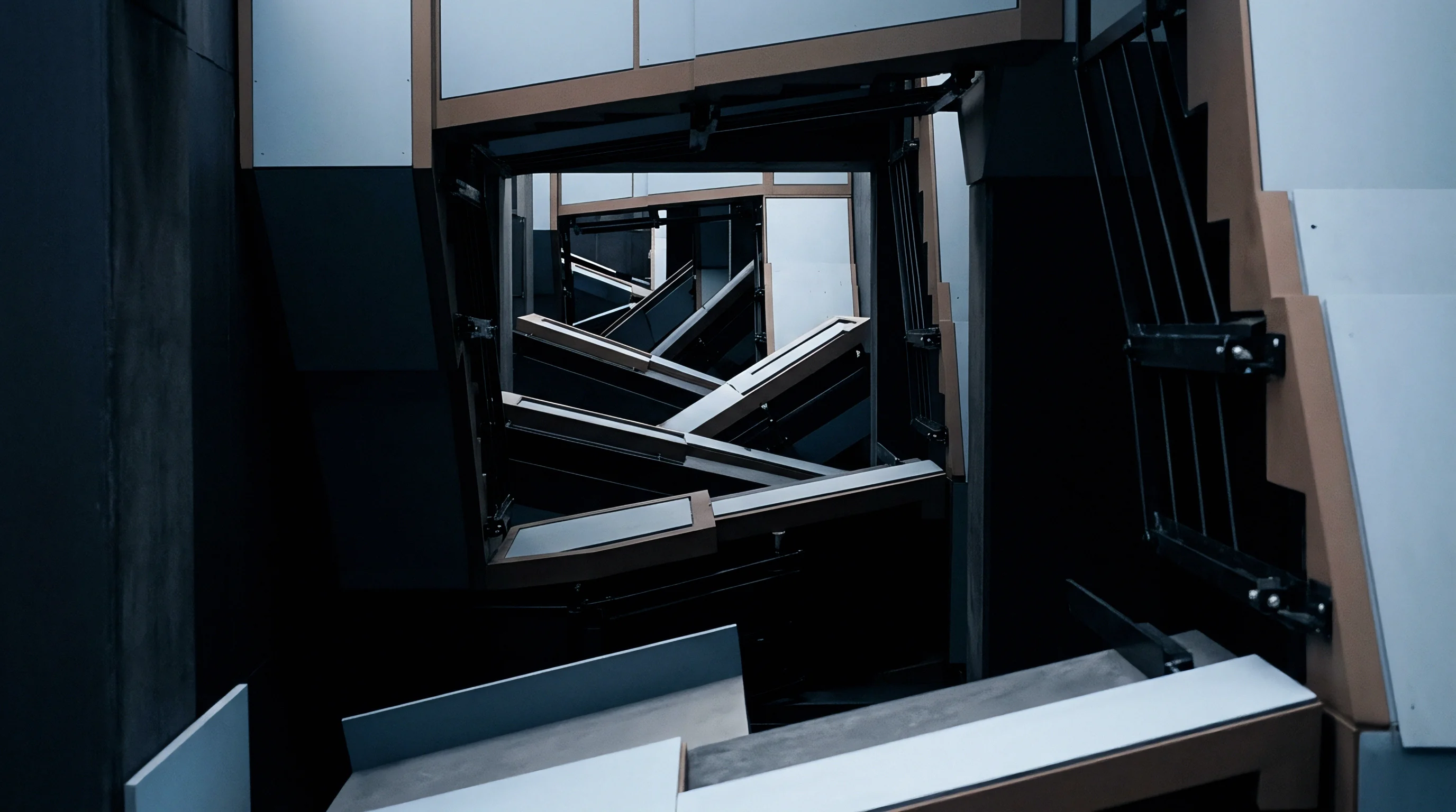 Metallic modular frames and angled conveyor tracks extend through repeated geometric chambers within an industrial assembly facility.