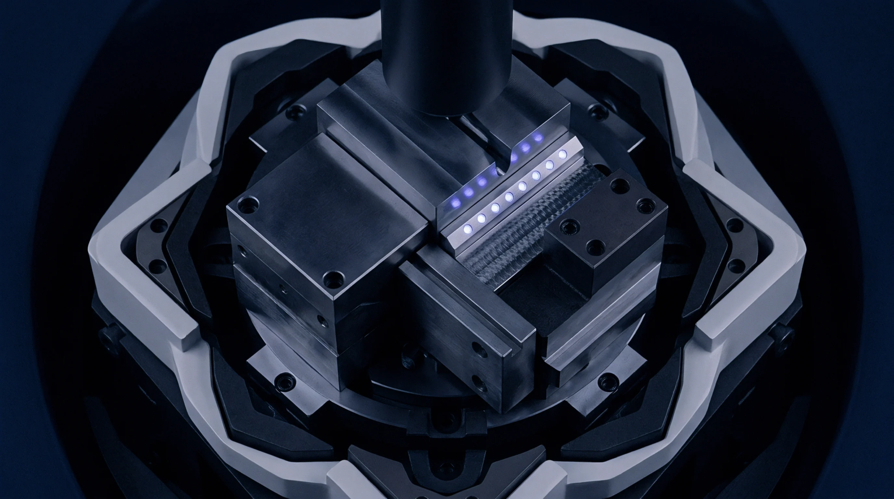 Four precision steel jaws converge on a central axis within an industrial assembly module equipped with integrated light emitting diode arrays.